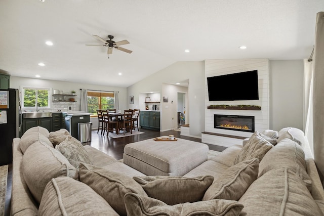 17561 Denkbar Loop, Park Rapids, MN 56470 - living room featuring dark wood-type flooring, a large fireplace, lofted ceiling, a ceiling fan, and recessed lighting