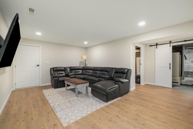 17561 Denkbar Loop, Park Rapids, MN 56470 - living room featuring a barn door, light wood-style flooring, and recessed lighting