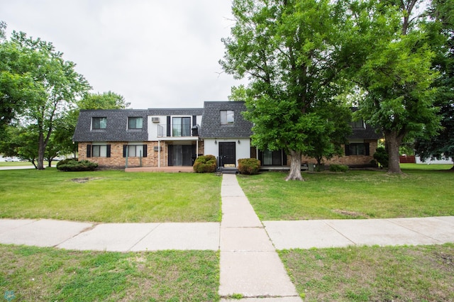 2417 Demores Dr S Unit 2, Fargo, ND 58103 - multi unit property featuring a shingled roof, a front lawn, brick siding, and mansard roof