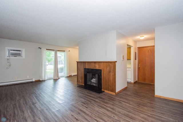 2417 Demores Dr S Unit 2, Fargo, ND 58103 - unfurnished living room featuring a wall unit AC, dark wood-type flooring, a fireplace with raised hearth, a baseboard heating unit, and a baseboard radiator