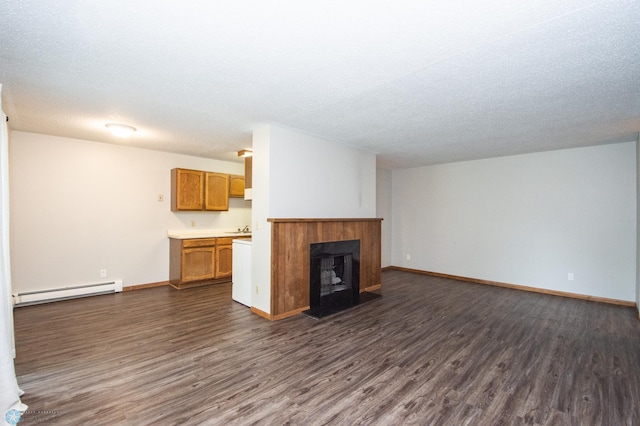 2417 Demores Dr S Unit 2, Fargo, ND 58103 - unfurnished living room featuring baseboard heating, dark wood finished floors, a fireplace, and a textured ceiling