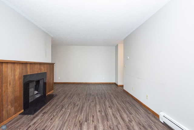 2417 Demores Dr S Unit 2, Fargo, ND 58103 - unfurnished living room featuring a baseboard radiator, dark wood-type flooring, and a fireplace with raised hearth