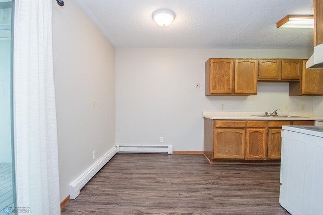 2417 Demores Dr S Unit 2, Fargo, ND 58103 - kitchen with a baseboard heating unit, washer / clothes dryer, light countertops, dark wood finished floors, and a textured ceiling