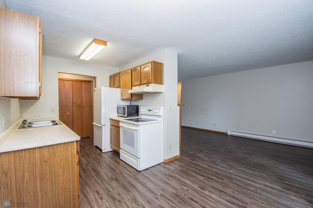 2417 Demores Dr S Unit 2, Fargo, ND 58103 - kitchen featuring white appliances, under cabinet range hood, dark wood finished floors, light countertops, and a baseboard heating unit