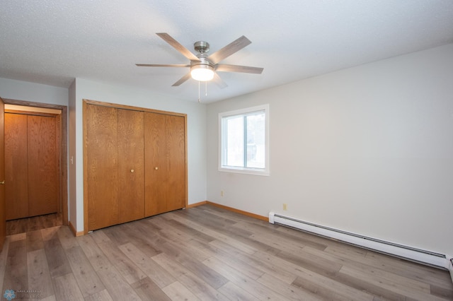 2417 Demores Dr S Unit 2, Fargo, ND 58103 - unfurnished bedroom featuring baseboard heating, a closet, light wood-style flooring, and ceiling fan