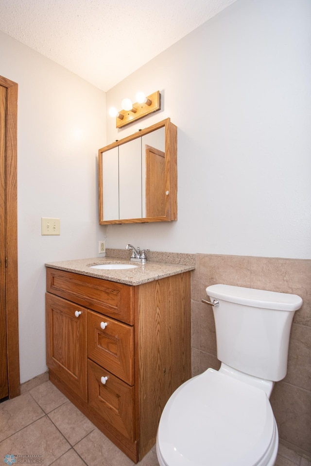 2417 Demores Dr S Unit 2, Fargo, ND 58103 - half bath with vanity, tile patterned floors, wainscoting, and tile walls