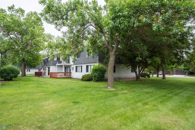2417 Demores Dr S Unit 2, Fargo, ND 58103 - view of grassy yard with a wooden deck