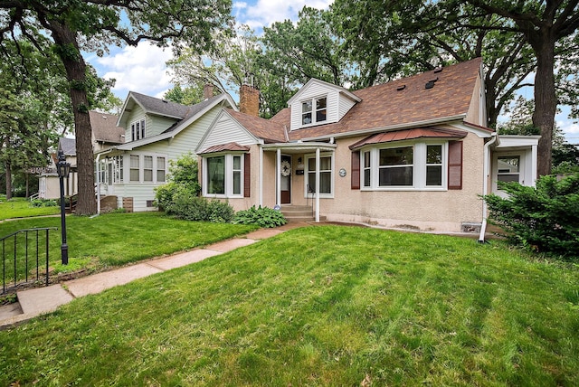 1442 Como Ave, Saint Paul, MN 55108 - cape cod-style house with a front lawn, a shingled roof, and a chimney