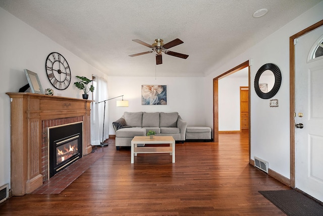 1442 Como Ave, Saint Paul, MN 55108 - living area with ceiling fan, dark wood-type flooring, a fireplace with flush hearth, and a textured ceiling