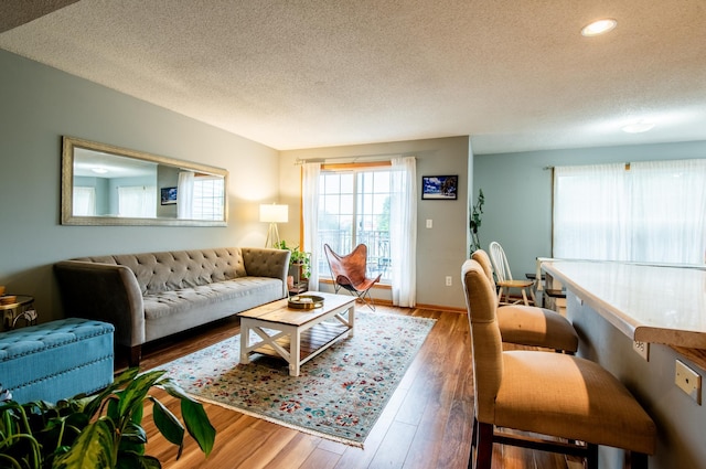 5724 4th St NE, Fridley, MN 55432 - living room with a textured ceiling, wood finished floors, and recessed lighting