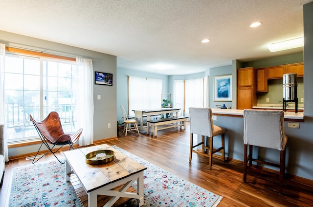5724 4th St NE, Fridley, MN 55432 - living area featuring healthy amount of natural light, a textured ceiling, recessed lighting, and wood finished floors