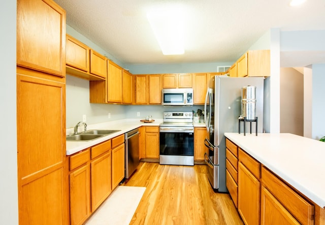 5724 4th St NE, Fridley, MN 55432 - kitchen featuring appliances with stainless steel finishes, light wood-type flooring, and light countertops
