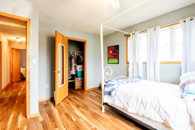 5724 4th St NE, Fridley, MN 55432 - bedroom with light wood finished floors, a closet, a walk in closet, and ceiling fan