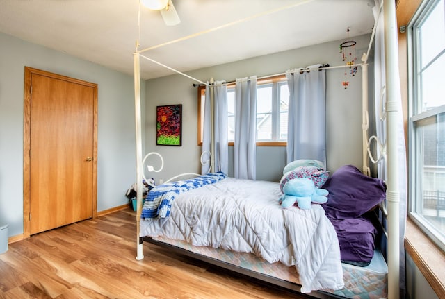 5724 4th St NE, Fridley, MN 55432 - bedroom featuring multiple windows, light wood-style flooring, and ceiling fan