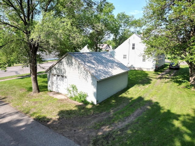 302 30th Ave N, Saint Cloud, MN 56303 - view of home's exterior with an outbuilding, a yard, a metal roof, and a garage