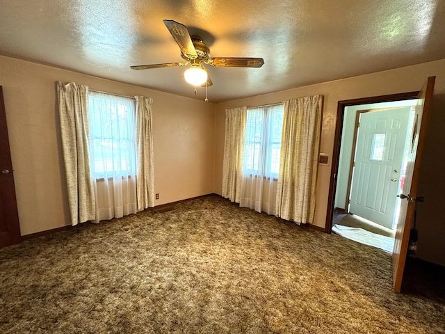 302 30th Ave N, Saint Cloud, MN 56303 - carpeted empty room with plenty of natural light, a textured ceiling, and a ceiling fan