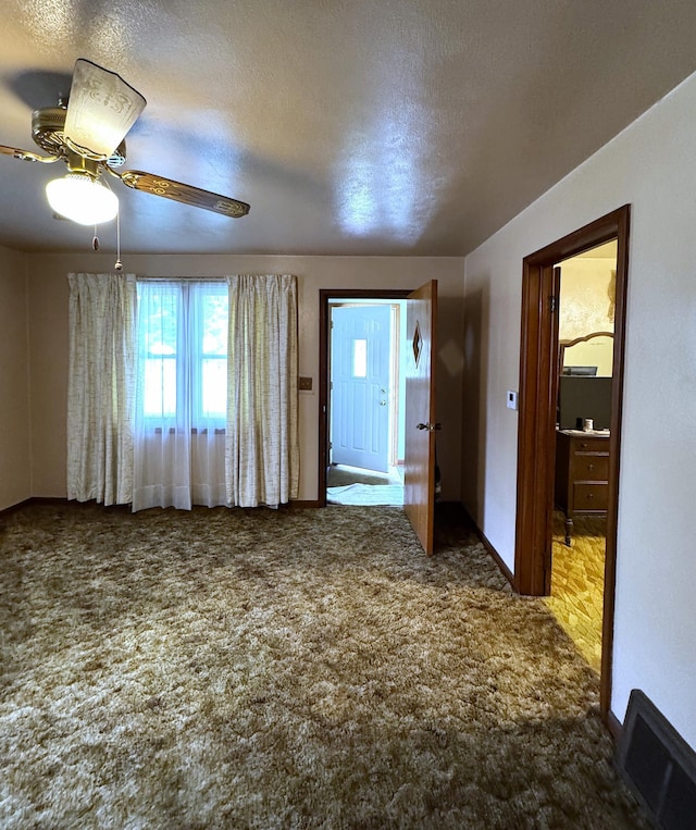 302 30th Ave N, Saint Cloud, MN 56303 - spare room with carpet, a ceiling fan, and a textured ceiling