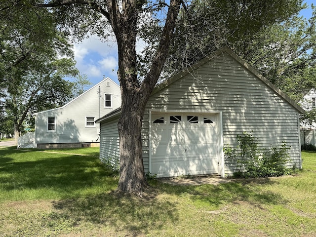 302 30th Ave N, Saint Cloud, MN 56303 - view of property exterior with a detached garage and a lawn