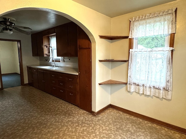 302 30th Ave N, Saint Cloud, MN 56303 - kitchen featuring open shelves, arched walkways, a ceiling fan, dark brown cabinetry, and tile patterned floors