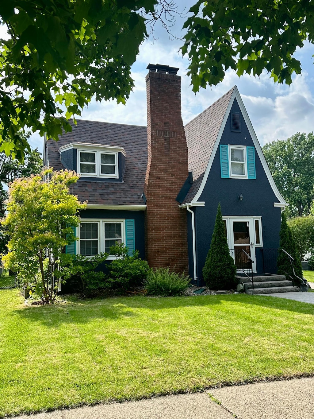 917 Bidwell St, West Saint Paul, MN 55118 - view of front of home featuring a chimney, a front yard, and a shingled roof
