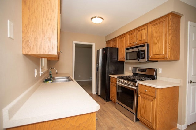 29930 Nathan Ct, Lindstrom, MN 55045 - kitchen featuring appliances with stainless steel finishes, light wood-type flooring, light countertops, and brown cabinets