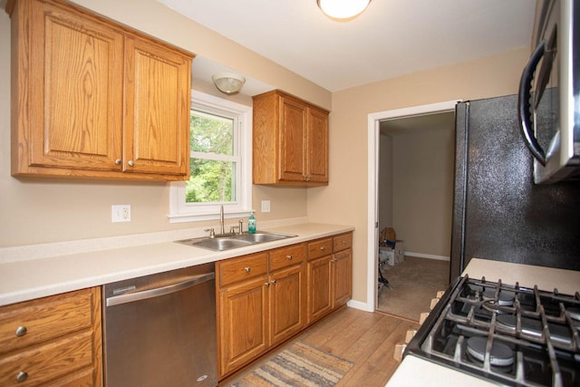 29930 Nathan Ct, Lindstrom, MN 55045 - kitchen featuring black appliances, light wood-style floors, brown cabinets, and light countertops