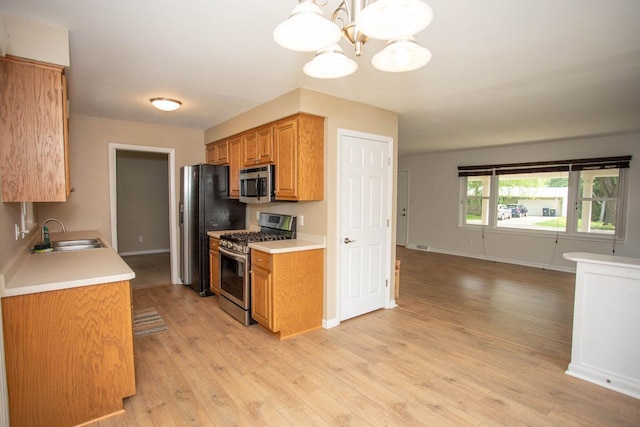 29930 Nathan Ct, Lindstrom, MN 55045 - kitchen featuring stainless steel appliances, light countertops, and light wood finished floors