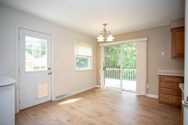 29930 Nathan Ct, Lindstrom, MN 55045 - unfurnished dining area with a chandelier, plenty of natural light, and light wood-style floors