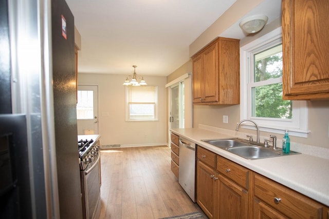 29930 Nathan Ct, Lindstrom, MN 55045 - kitchen with stainless steel appliances, brown cabinets, light wood-style floors, and light countertops