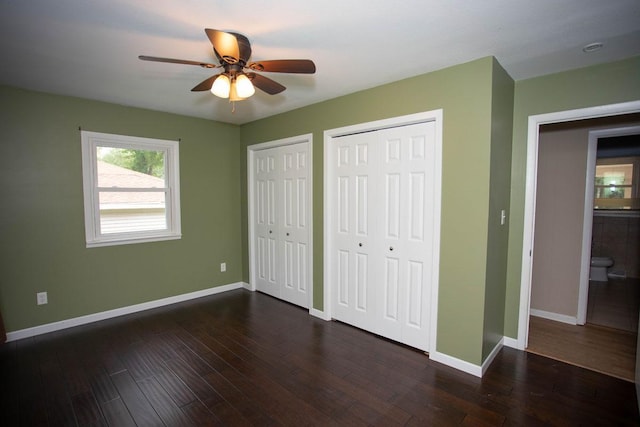 29930 Nathan Ct, Lindstrom, MN 55045 - unfurnished bedroom featuring multiple closets, dark wood-style flooring, and a ceiling fan