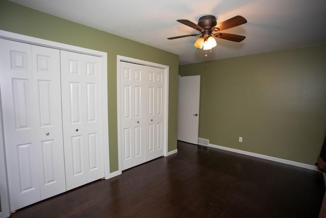 29930 Nathan Ct, Lindstrom, MN 55045 - unfurnished bedroom featuring two closets, dark wood finished floors, and ceiling fan
