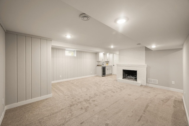 5644 Upton Ave S, Minneapolis, MN 55410 - basement featuring light colored carpet, a brick fireplace, and beverage cooler