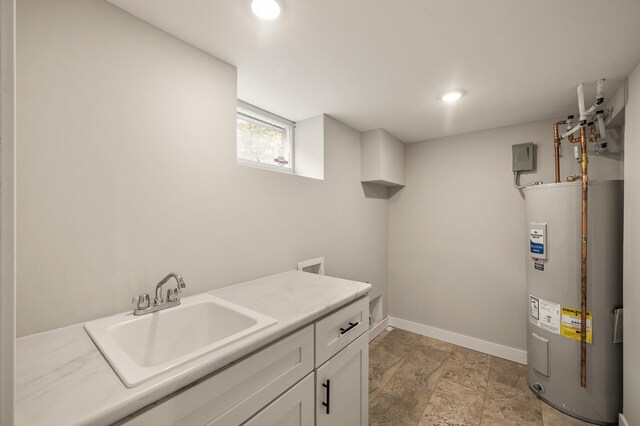 5644 Upton Ave S, Minneapolis, MN 55410 - laundry area with water heater, cabinet space, recessed lighting, and light stone finish floors