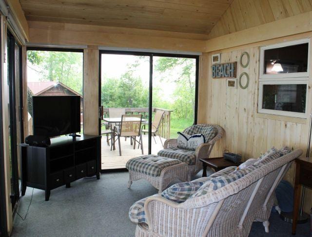 47393 209th Pl, Mcgregor, MN 55760 - carpeted living area featuring wooden ceiling, healthy amount of natural light, lofted ceiling, and wooden walls