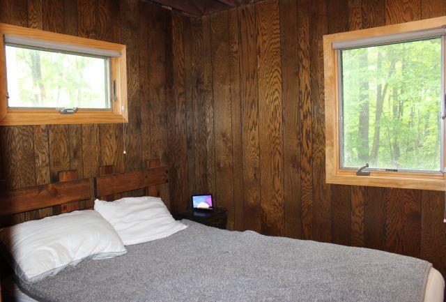 47393 209th Pl, Mcgregor, MN 55760 - bedroom featuring wood walls and multiple windows