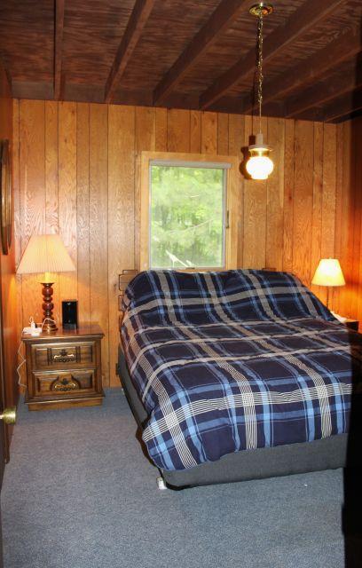 47393 209th Pl, Mcgregor, MN 55760 - carpeted bedroom with a wood ceiling with exposed beams and wooden walls