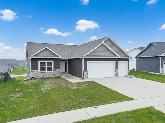 837 Towne Dr NE, Byron, MN 55920 - craftsman inspired home with stone siding, an attached garage, driveway, and a front yard