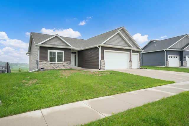 837 Towne Dr NE, Byron, MN 55920 - view of front of property featuring an attached garage, stone siding, a front lawn, and driveway