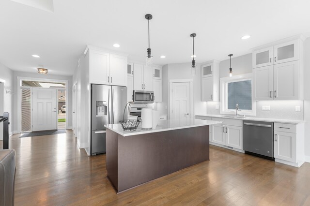 837 Towne Dr NE, Byron, MN 55920 - kitchen with appliances with stainless steel finishes, dark wood-type flooring, light countertops, decorative backsplash, and recessed lighting