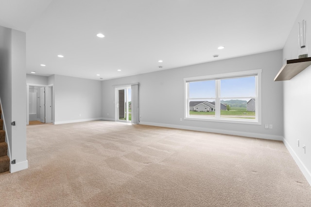 837 Towne Dr NE, Byron, MN 55920 - spare room with light colored carpet, healthy amount of natural light, recessed lighting, and stairway