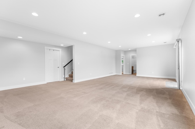 837 Towne Dr NE, Byron, MN 55920 - unfurnished living room featuring recessed lighting, light carpet, and stairs
