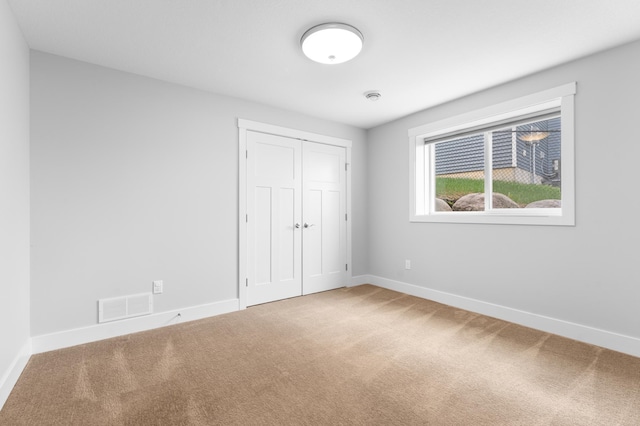 837 Towne Dr NE, Byron, MN 55920 - unfurnished bedroom featuring carpet floors and a closet