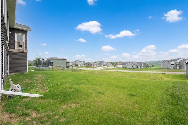 837 Towne Dr NE, Byron, MN 55920 - view of grassy yard featuring a trampoline and a residential view