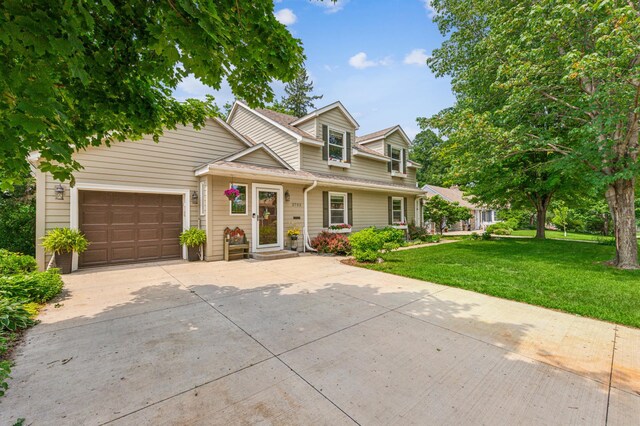 3703 Beard Ave N, Robbinsdale, MN 55422 - view of front of property featuring driveway, a front lawn, and a garage