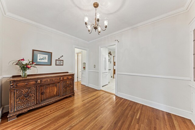 3703 Beard Ave N, Robbinsdale, MN 55422 - dining room with a chandelier, wood finished floors, and ornamental molding