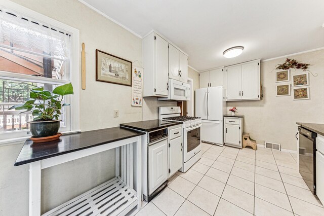 3703 Beard Ave N, Robbinsdale, MN 55422 - kitchen with white appliances, dark countertops, white cabinets, light tile patterned flooring, and ornamental molding