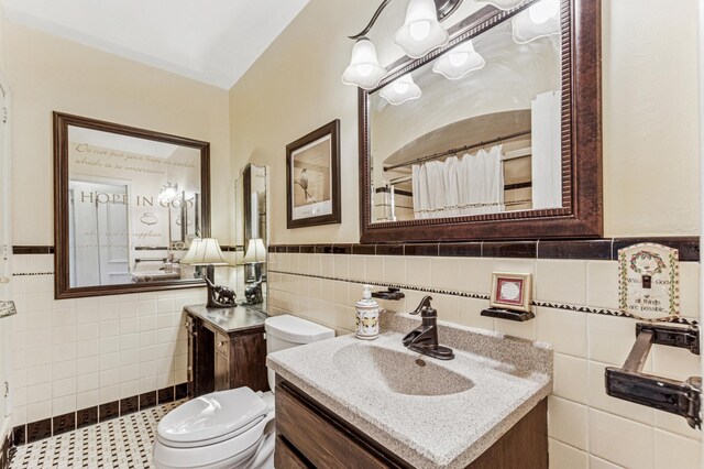 3703 Beard Ave N, Robbinsdale, MN 55422 - full bathroom featuring tile walls, vanity, a wainscoted wall, and a shower with shower curtain