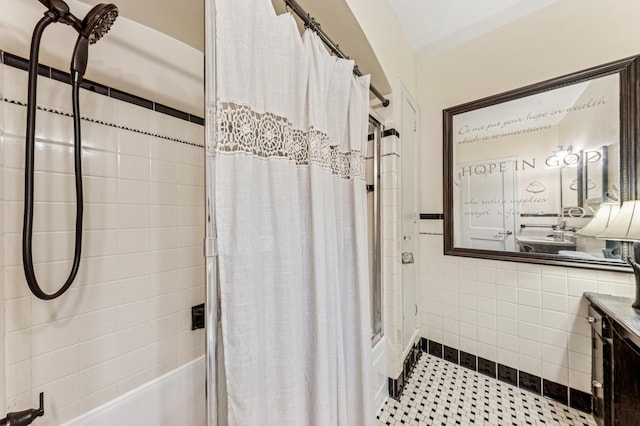 3703 Beard Ave N, Robbinsdale, MN 55422 - bathroom with shower / bath combination with curtain, tile walls, vanity, a wainscoted wall, and tile patterned floors