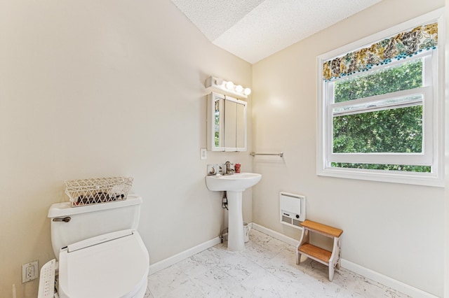 3703 Beard Ave N, Robbinsdale, MN 55422 - half bath with marble look tile flooring and a textured ceiling
