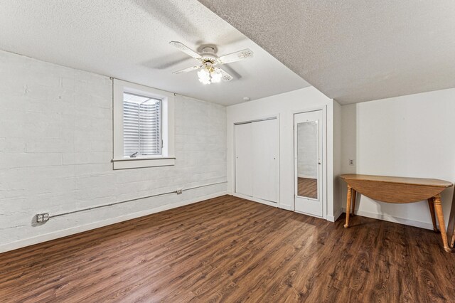 3703 Beard Ave N, Robbinsdale, MN 55422 - unfurnished bedroom with wood finished floors, a textured ceiling, ceiling fan, and multiple closets